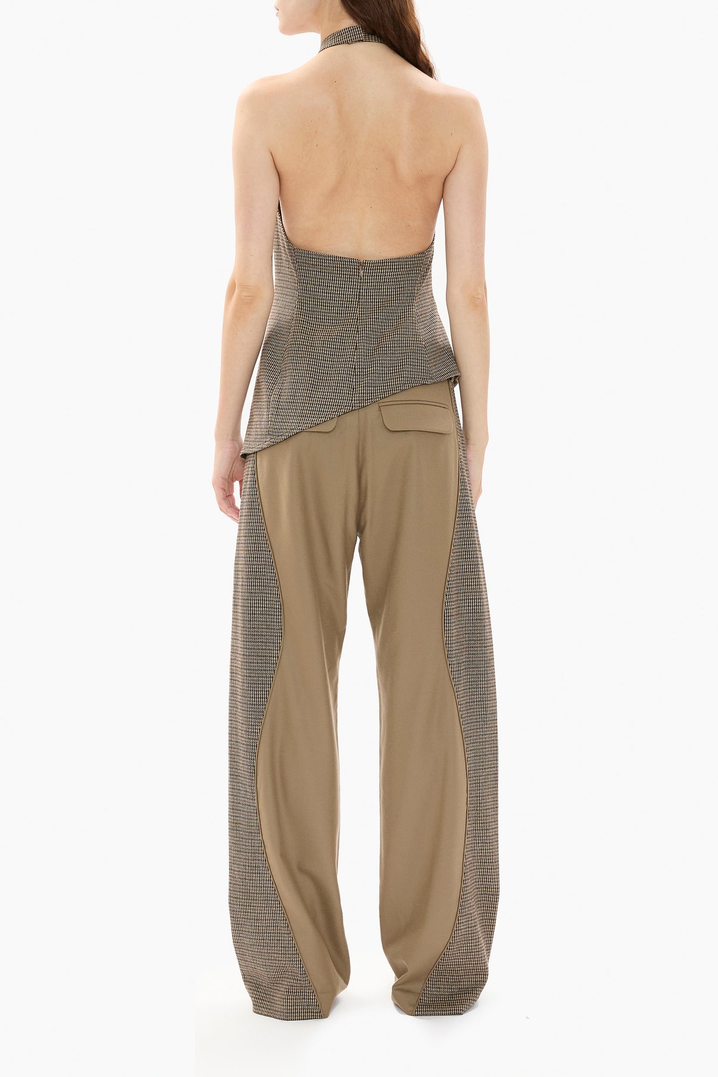 Woman wearing a houndstooth halter top and wide-leg pants with a houndstooth pattern on a white background