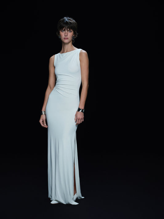 Woman wearing a vanilla white evening gown on a black background