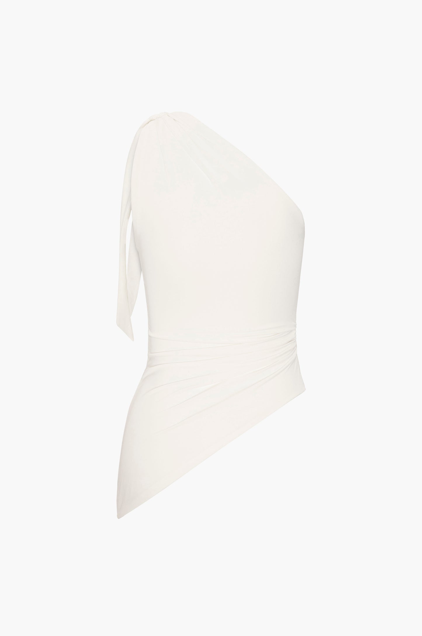 White one shoulder top on a light beige background