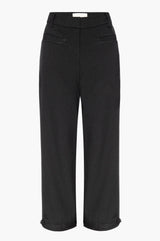 Black capri pants with front and back pockets and adjustable belt detail at the hem on a white background
