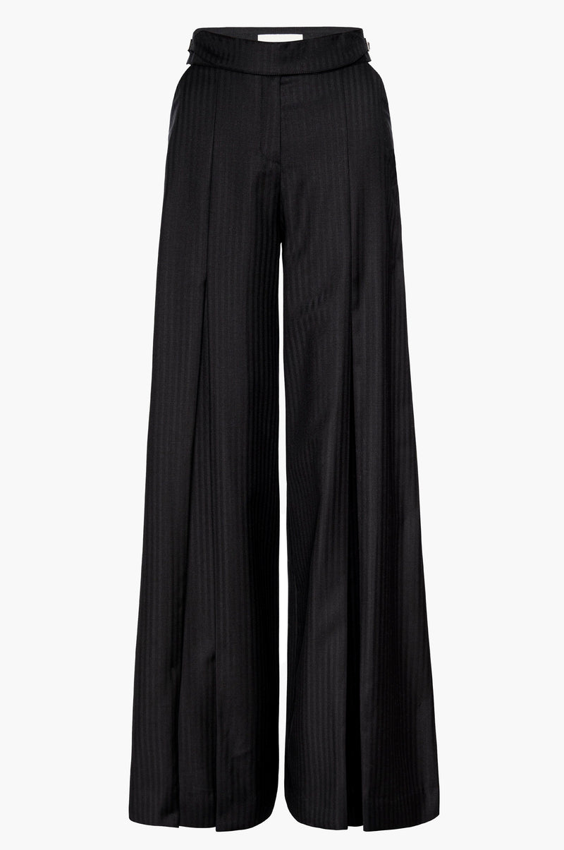 Pleated wide-leg trousers in black with cutouts at the hips and a buckle detail at the waistband on a white background