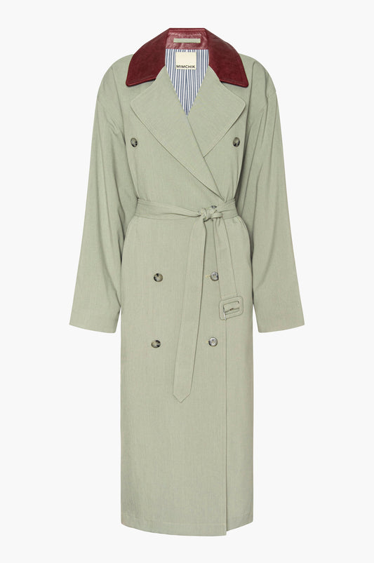 Seafoam green trench coat with a burgundy leather collar on a white background