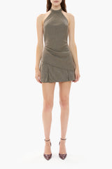 Woman wearing a brown houndstooth halter neck top and mini skirt on a white background