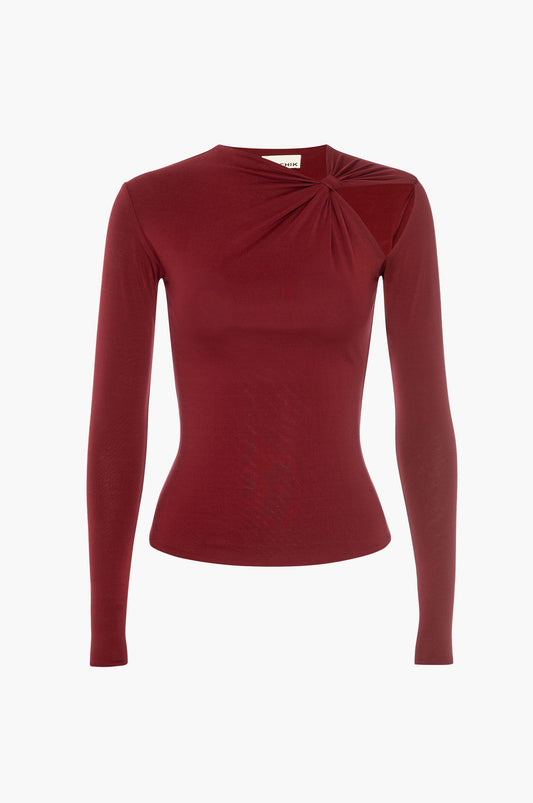 Burgundy red long-sleeve top with a knot cutout detail on a white background