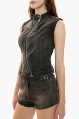 Woman wearing a black denim vest and shorts on a white background