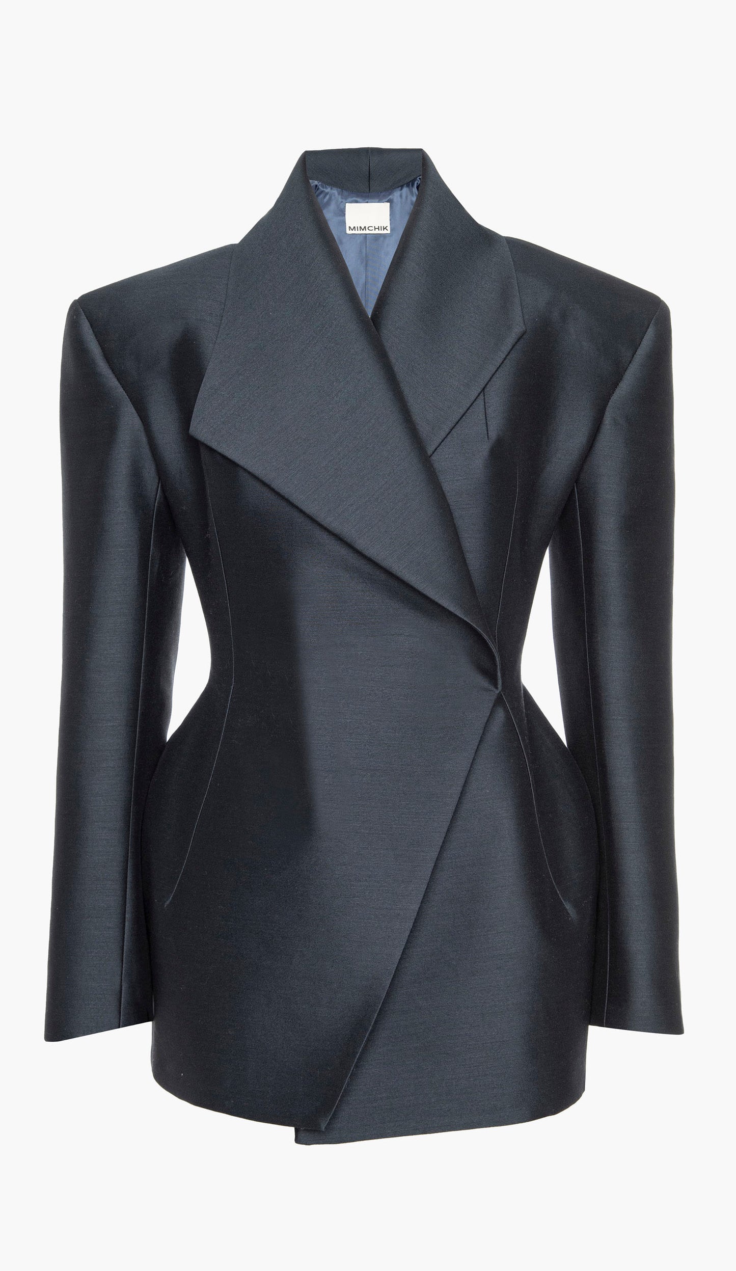 A navy blue silk wool blazer with an hourglass silhouette, asymmetrical shawl collar, and cinched waist on a white background