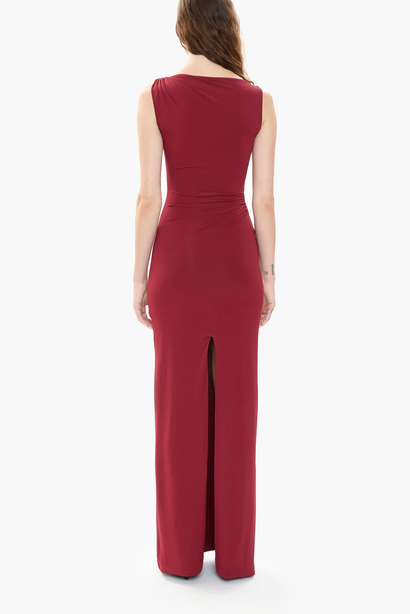 Back of a person wearing a burgundy gown on a white background
