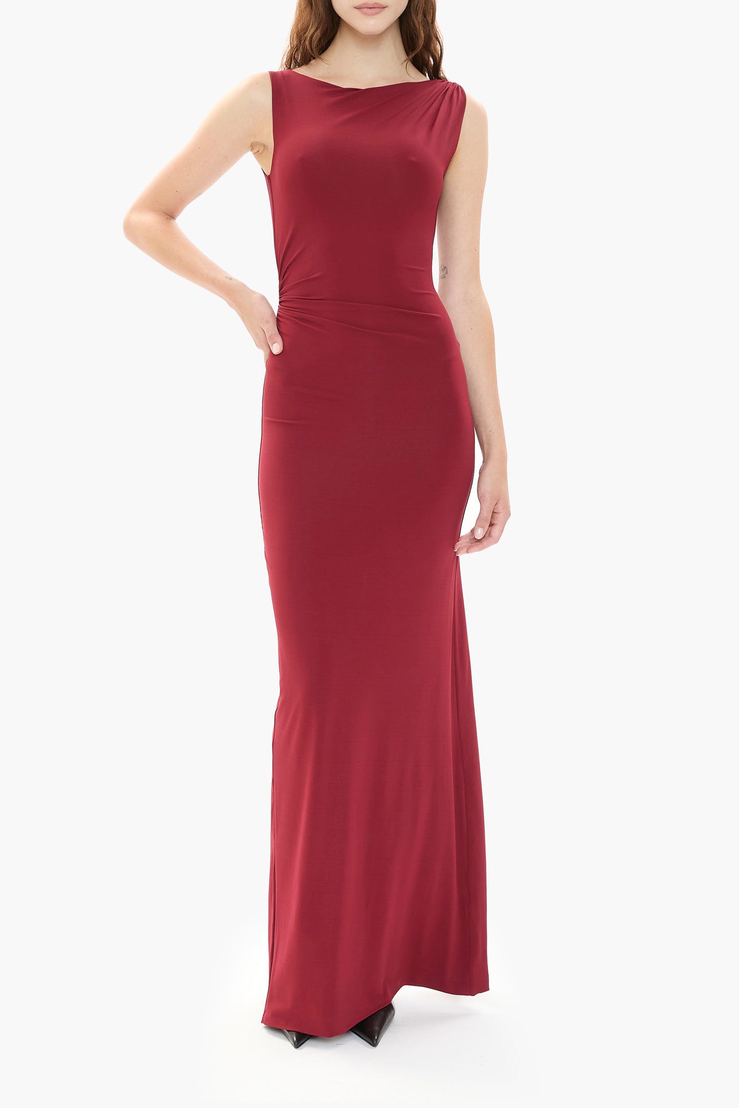 Person wearing a burgundy gown on a white background