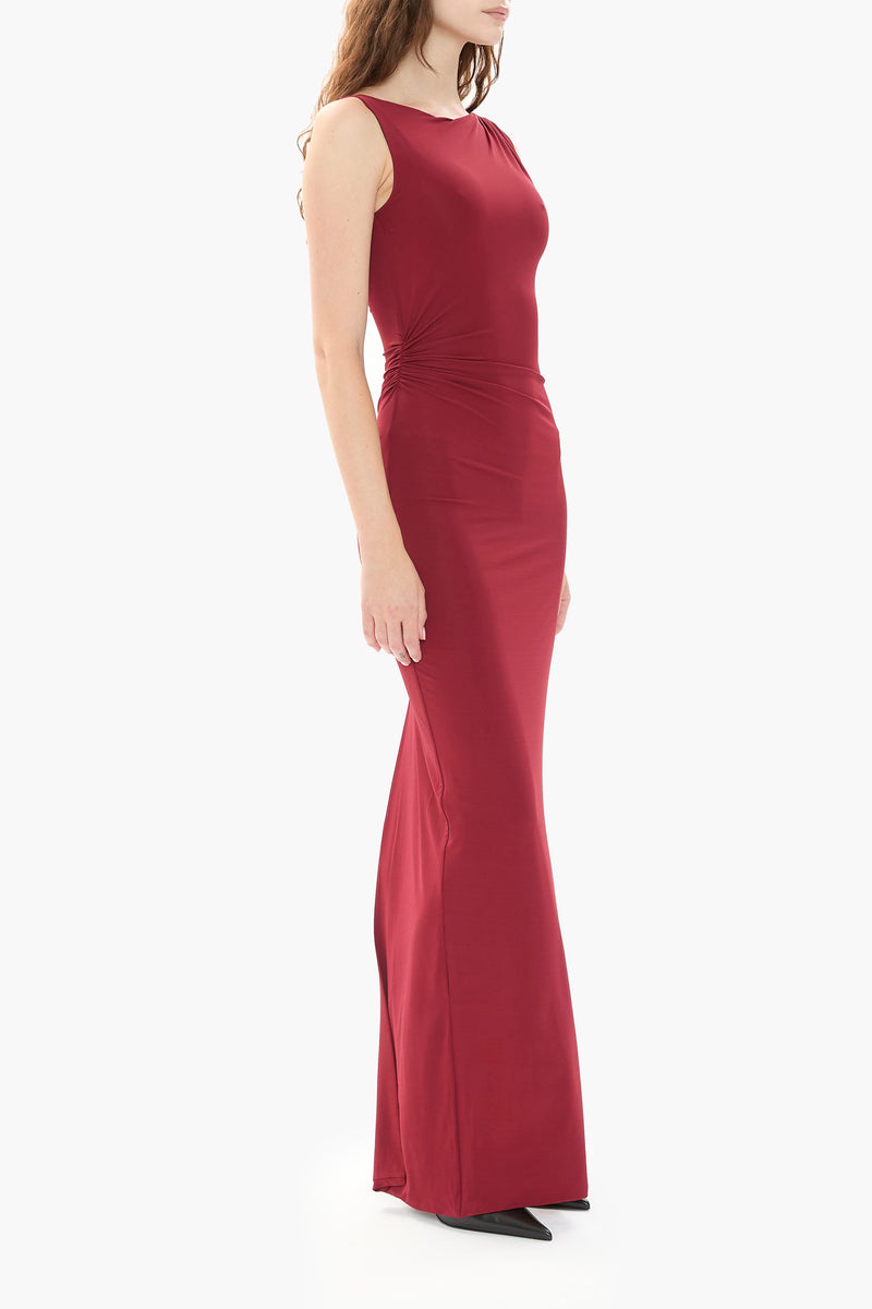 Person wearing a burgundy gown on a white background
