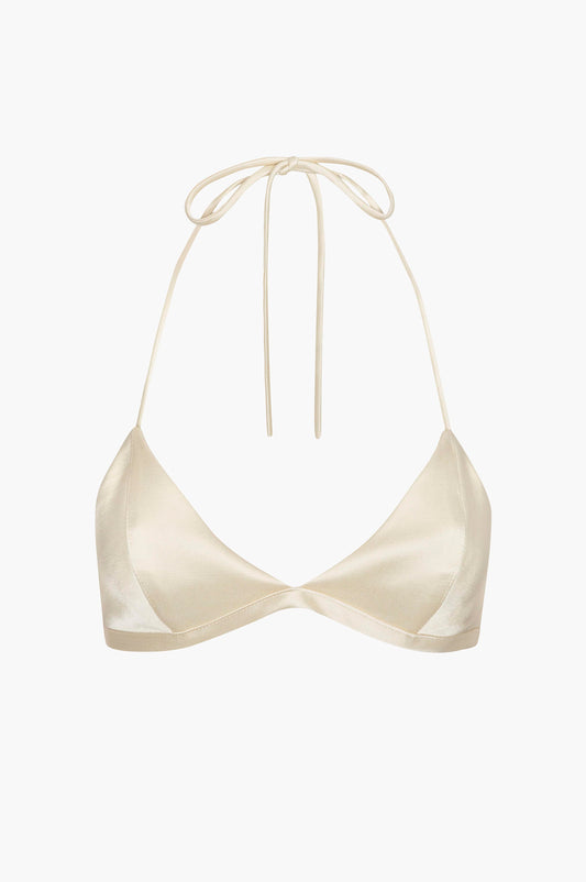 Custard satin bra top with a spaghetti strap halter tie on a white background