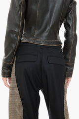 Dark brown leather jacket and black pants on a white background