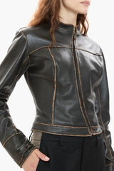Dark brown leather jacket worn by a person on a white background