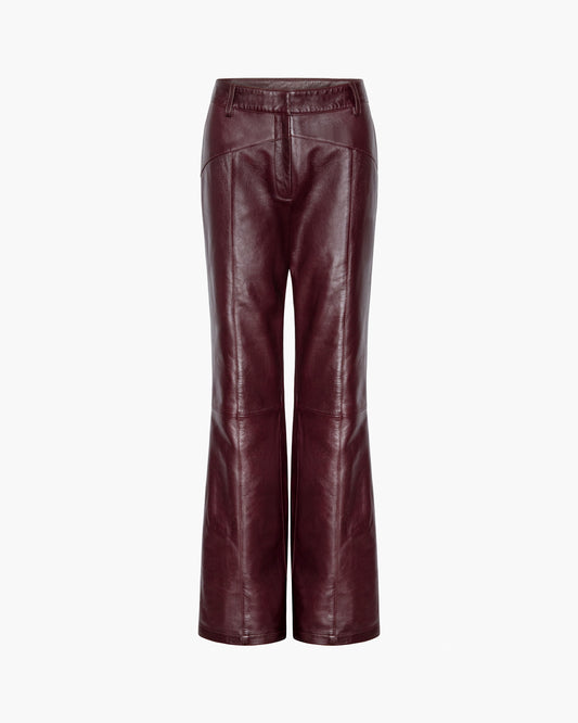 Pair of maroon leather pants on a white background