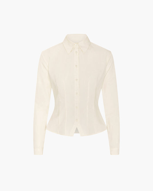 An off-white long-sleeve button-up shirt with a structured collar and a slightly fitted silhouette, displayed on a clean white background.