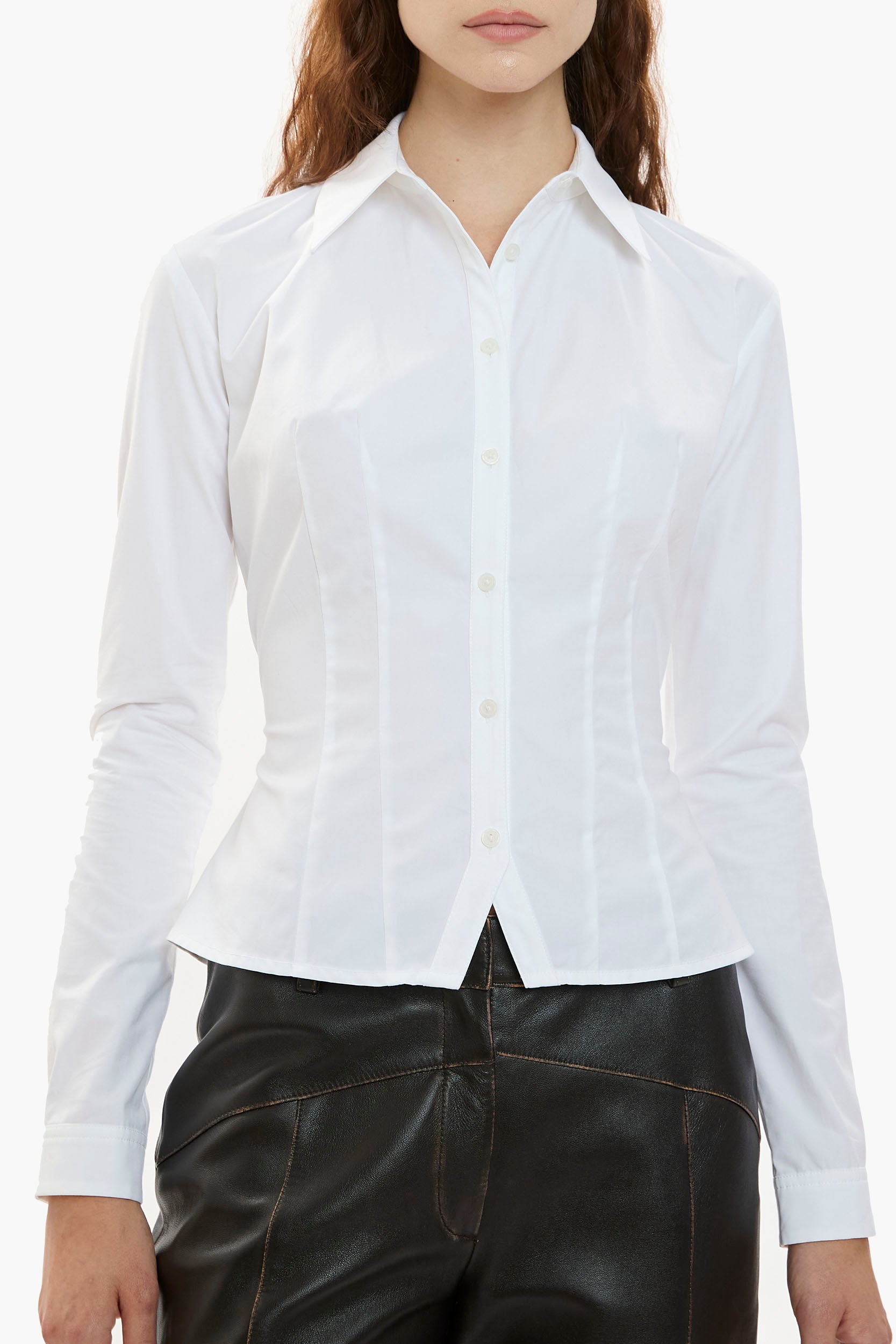 White button-down shirt worn by a person on a white background