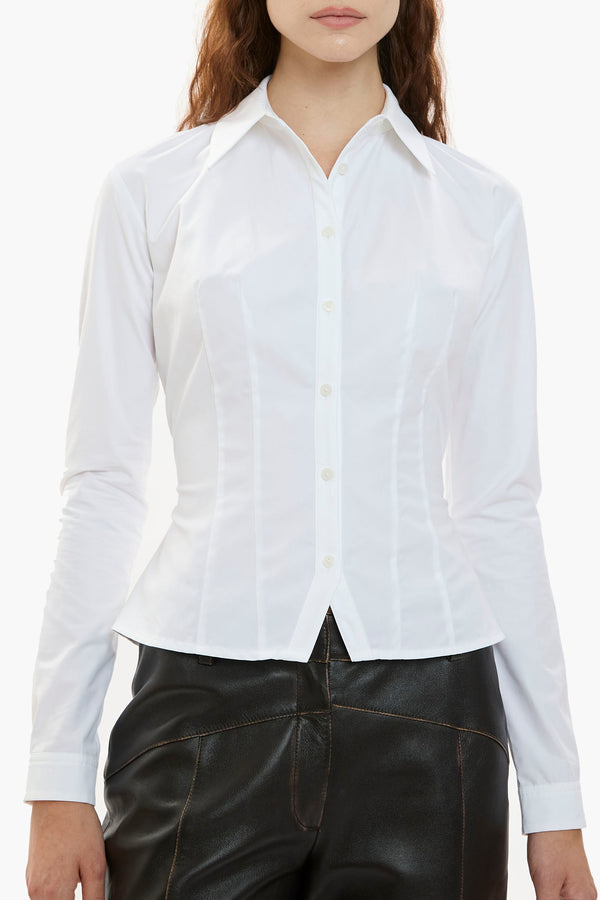 White button-down shirt worn by a person on a white background