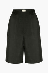 Dark green shorts on a white background