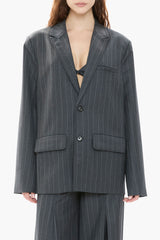 Person wearing a gray pinstripe suit with a white background