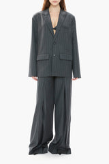 Person wearing a gray pinstripe suit on a white background